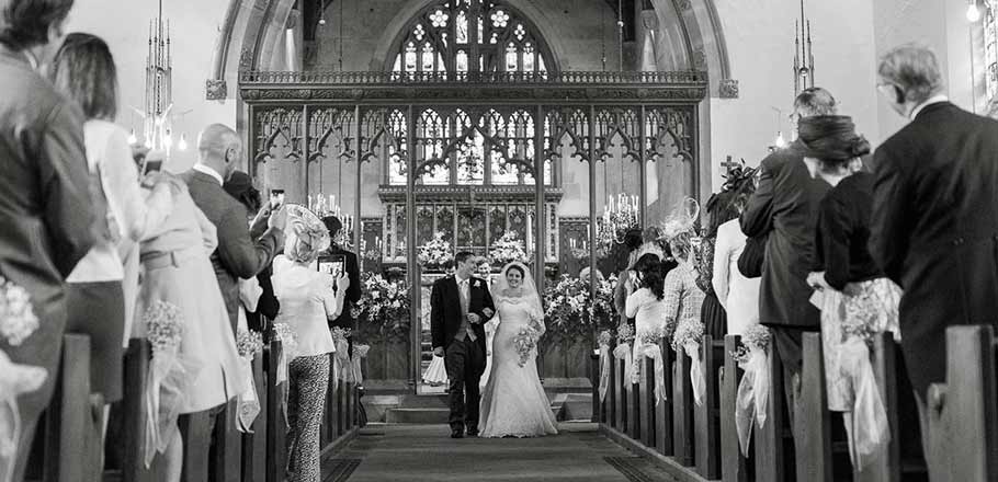 bride, groom and guests in a chapel wedding