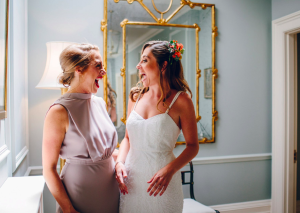 bride and bridesmaid laughing together