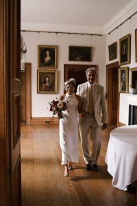 bride and father in portrait room
