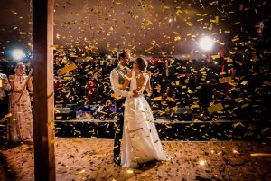 gold confetti on a bride and groom