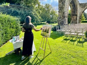 live wedding painter working at an outdoor wedding at Birdsall House