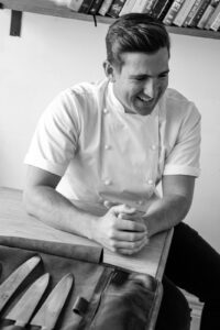 black and white image of smiling chef